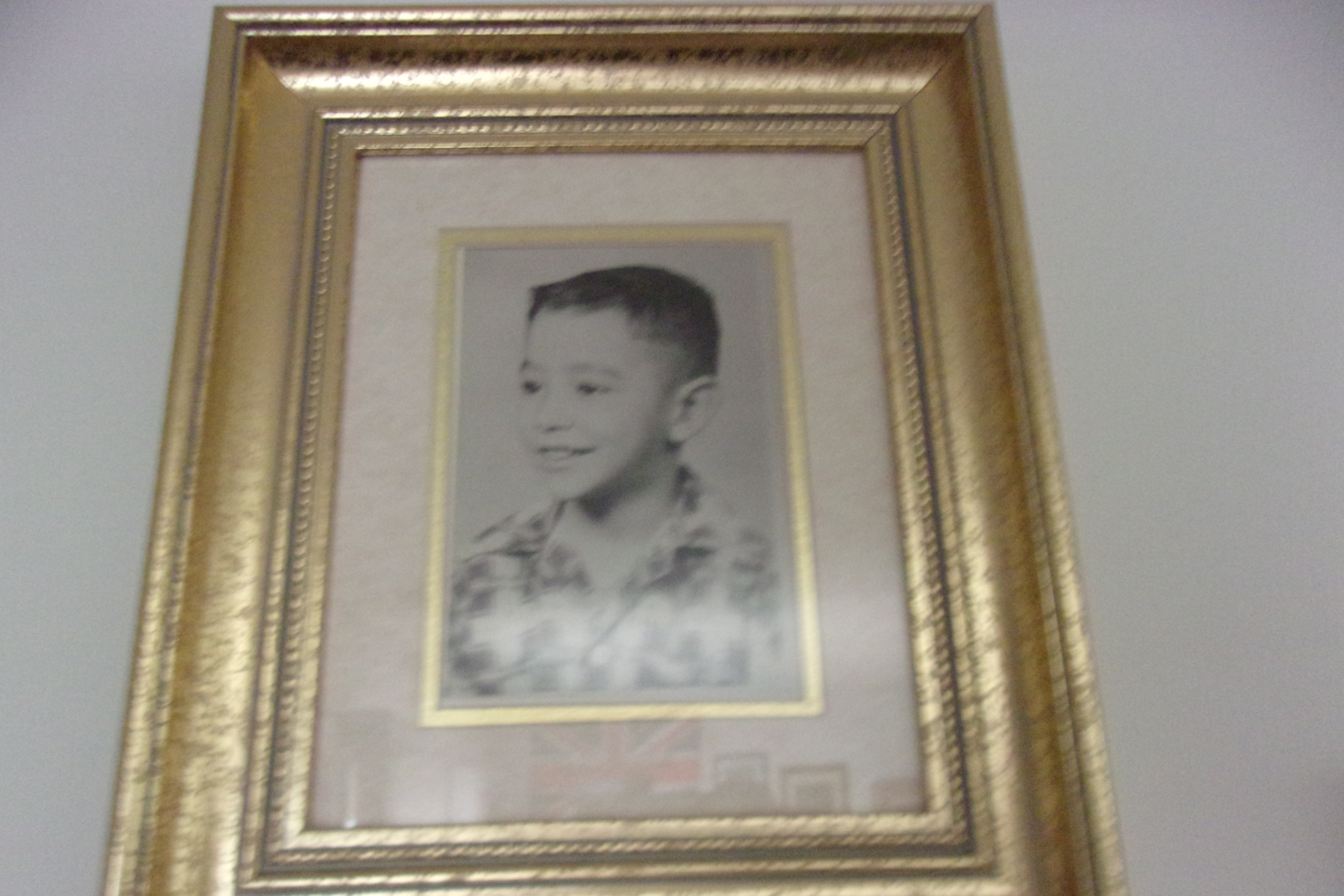 Black and white childhood portrait in gold frame